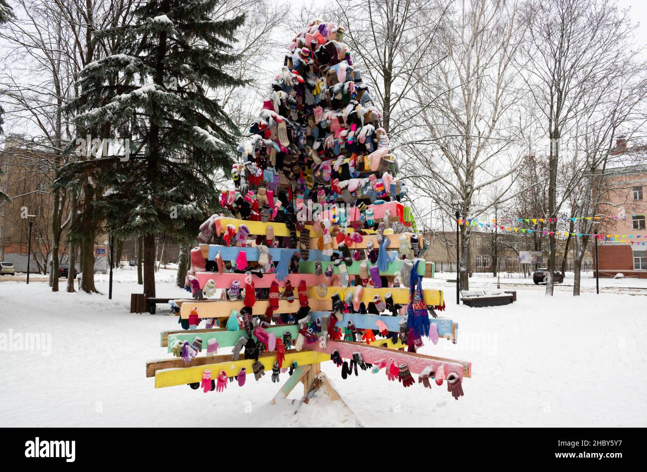 New Year's background with a Christmas wooden tree made of mittens. Stock Photo