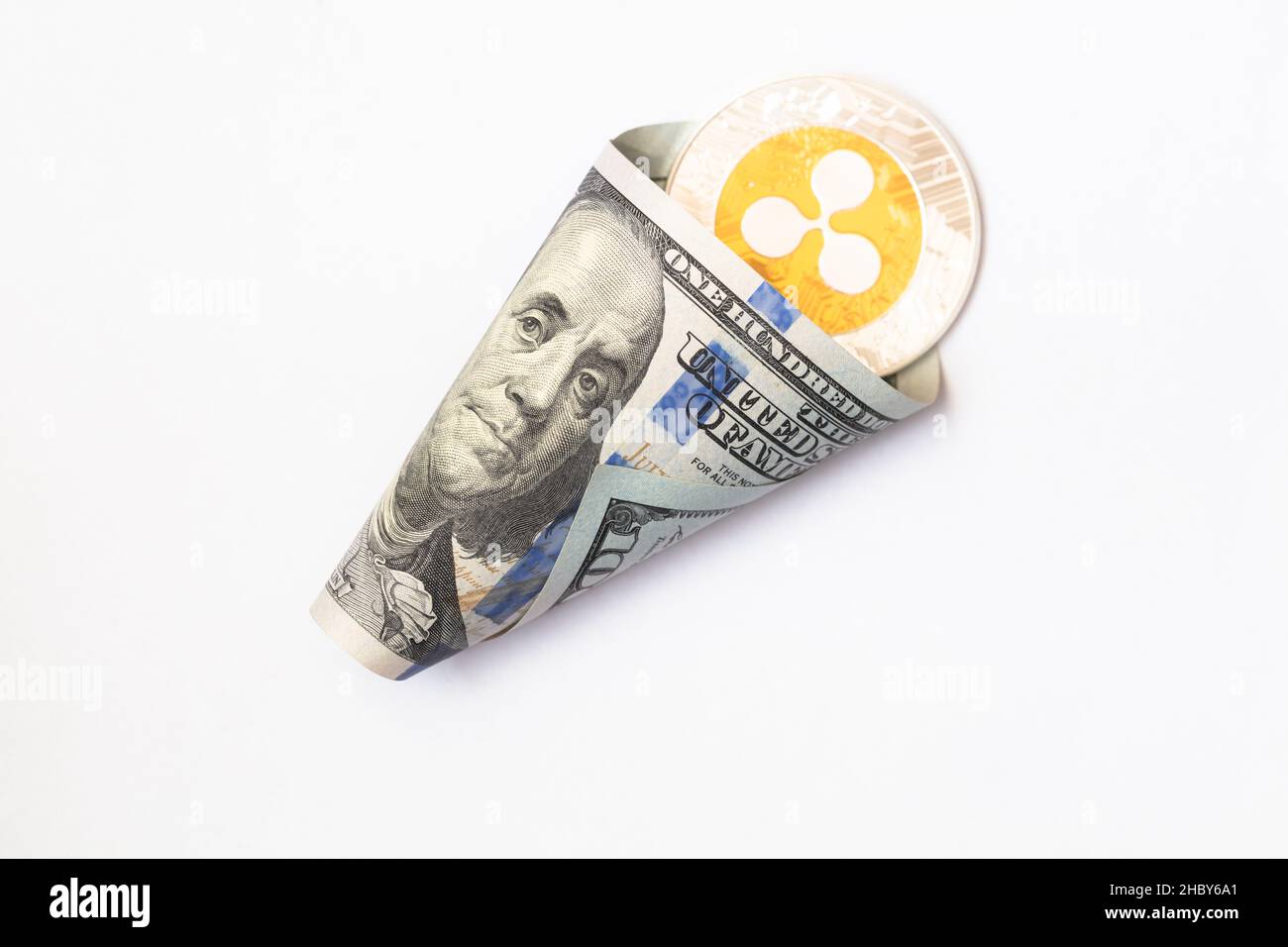 Ripple coin, XRP token, cryptocurrency on US 100 dollar background for