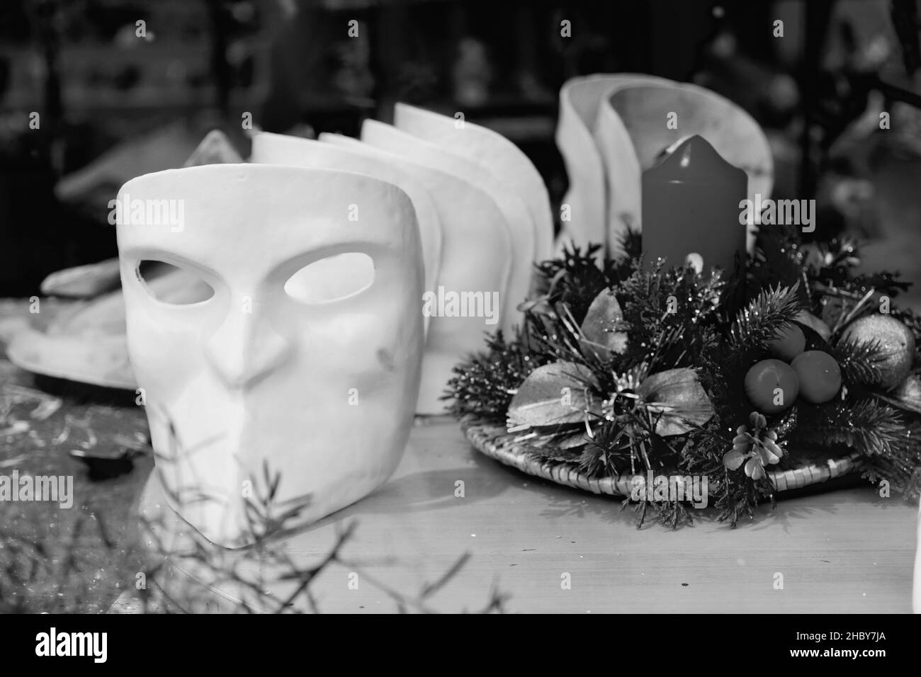 A grayscale closeup of the masks on the table. Venice, Italy. Stock Photo