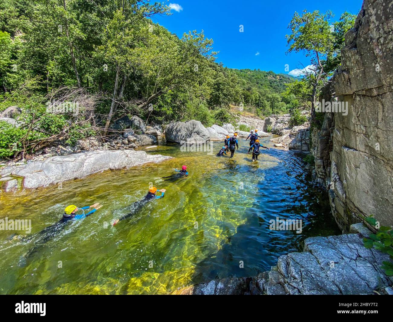 Back view of a group of people who are canyoning in Chassezac river in Lozere district in France Stock Photo