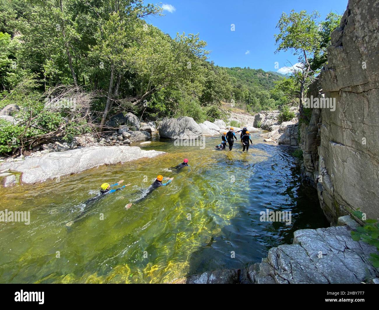 Back view of a group of people who are canyoning in Chassezac river in Lozere district in France Stock Photo