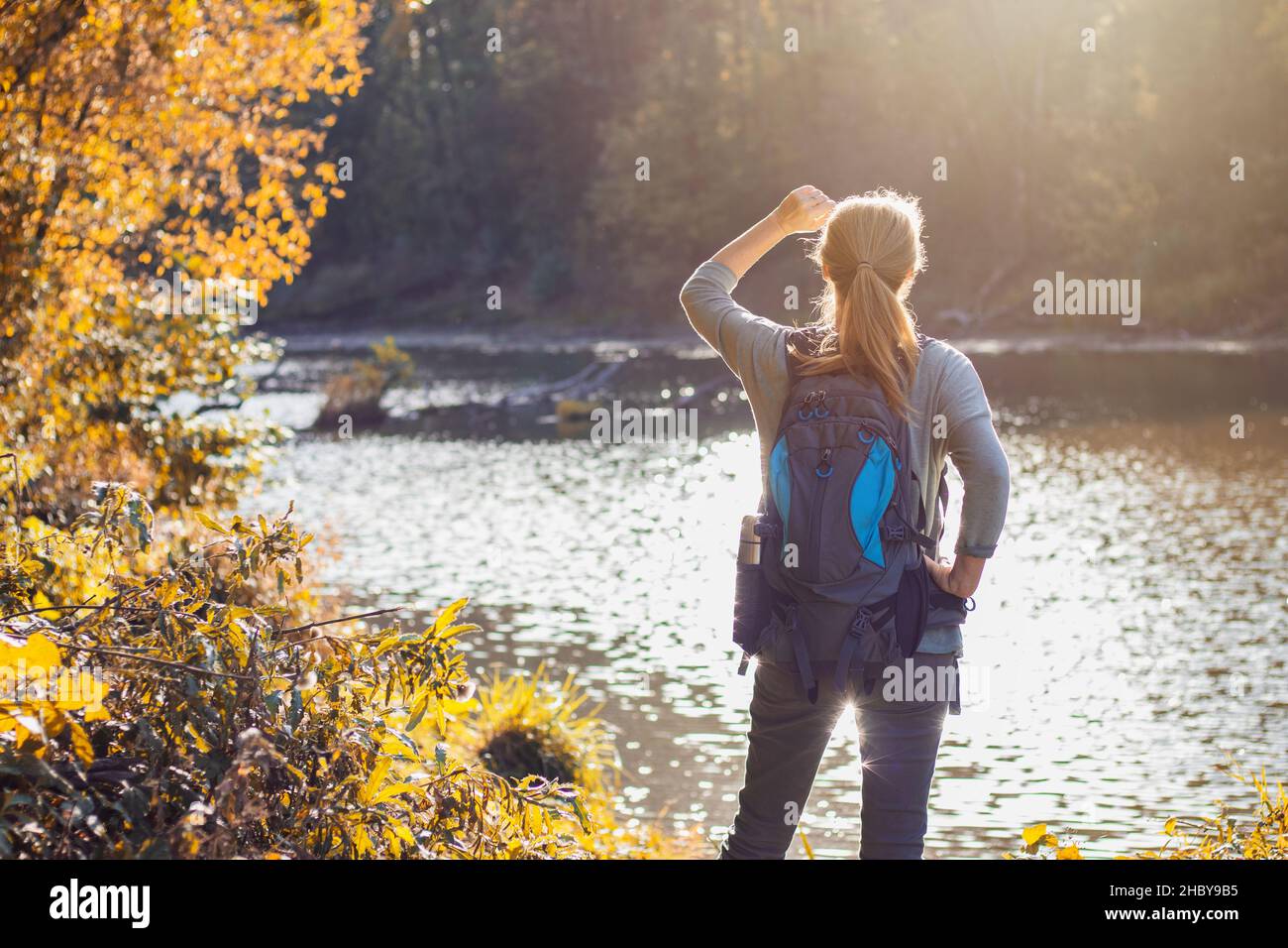 Woman standing by river hi-res stock photography and images - Alamy