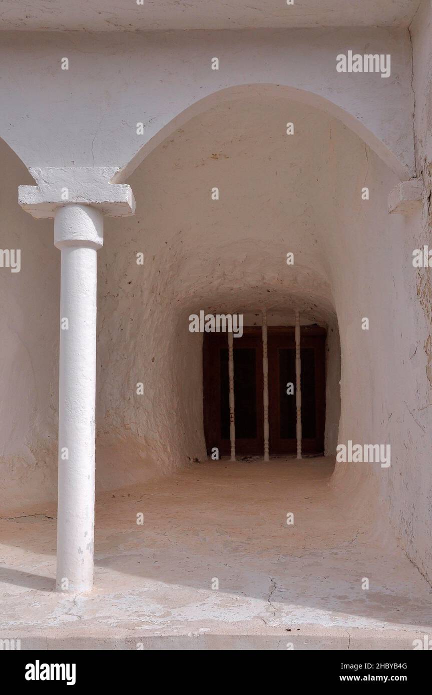 Round arch with column in front of barred window in cave house, Orce, Andalusia, Spain Stock Photo