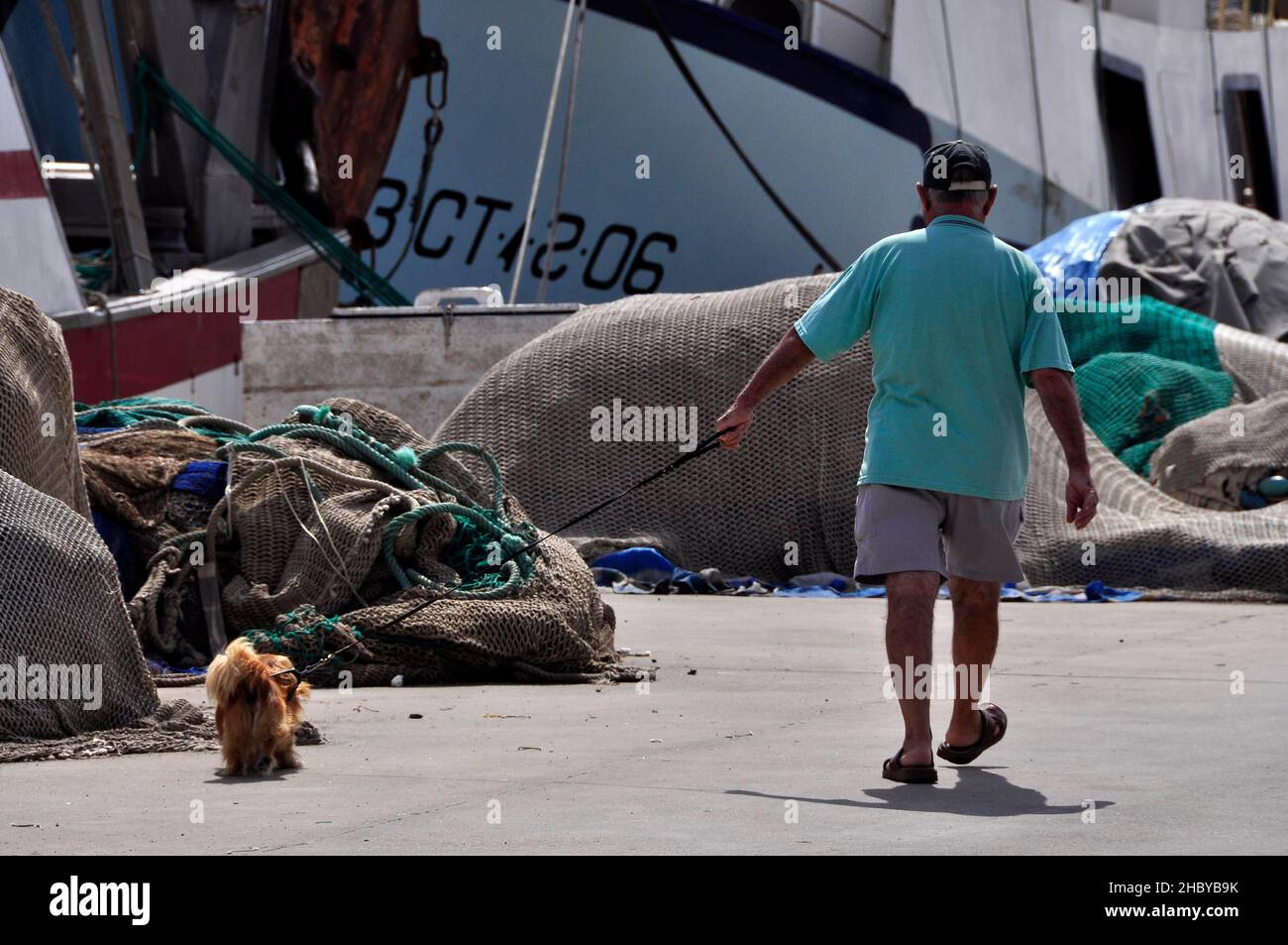 Master with dog on a leash in the harbour, Garrucha, Andalusia, Spain Stock Photo