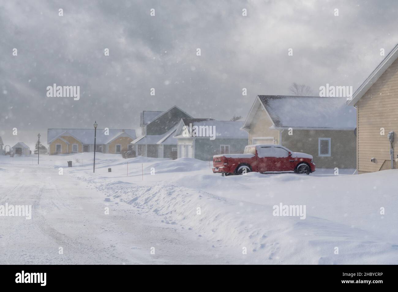 Snow falling over a suburban neighborhood. Stock Photo