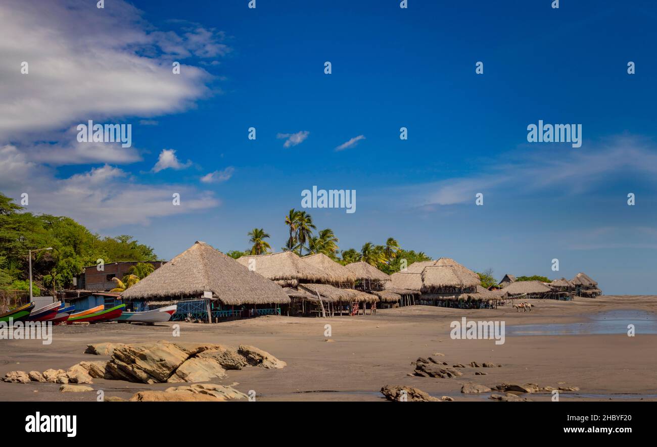 Thatched roof restaurants near the beach, thatched roof restaurant near wooden boats with blue sky, nicaragua restaurants near the beach Rivas Stock Photo