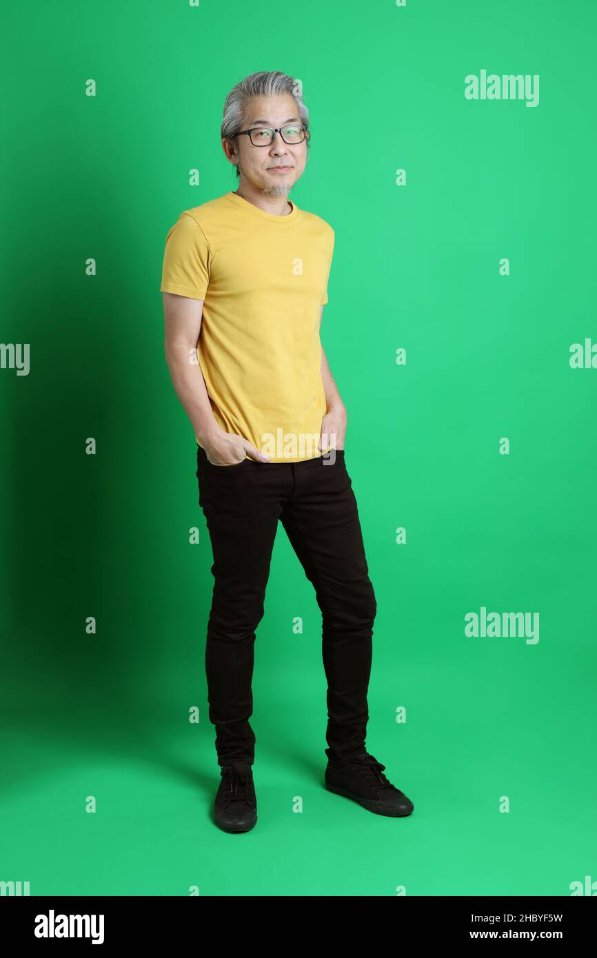 The Senior Asian Man With Long Gray Hair Standing On The Green