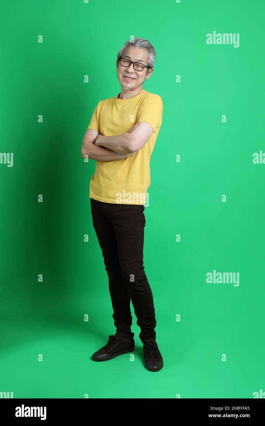 The Senior Asian Man With Long Gray Hair Standing On The Green