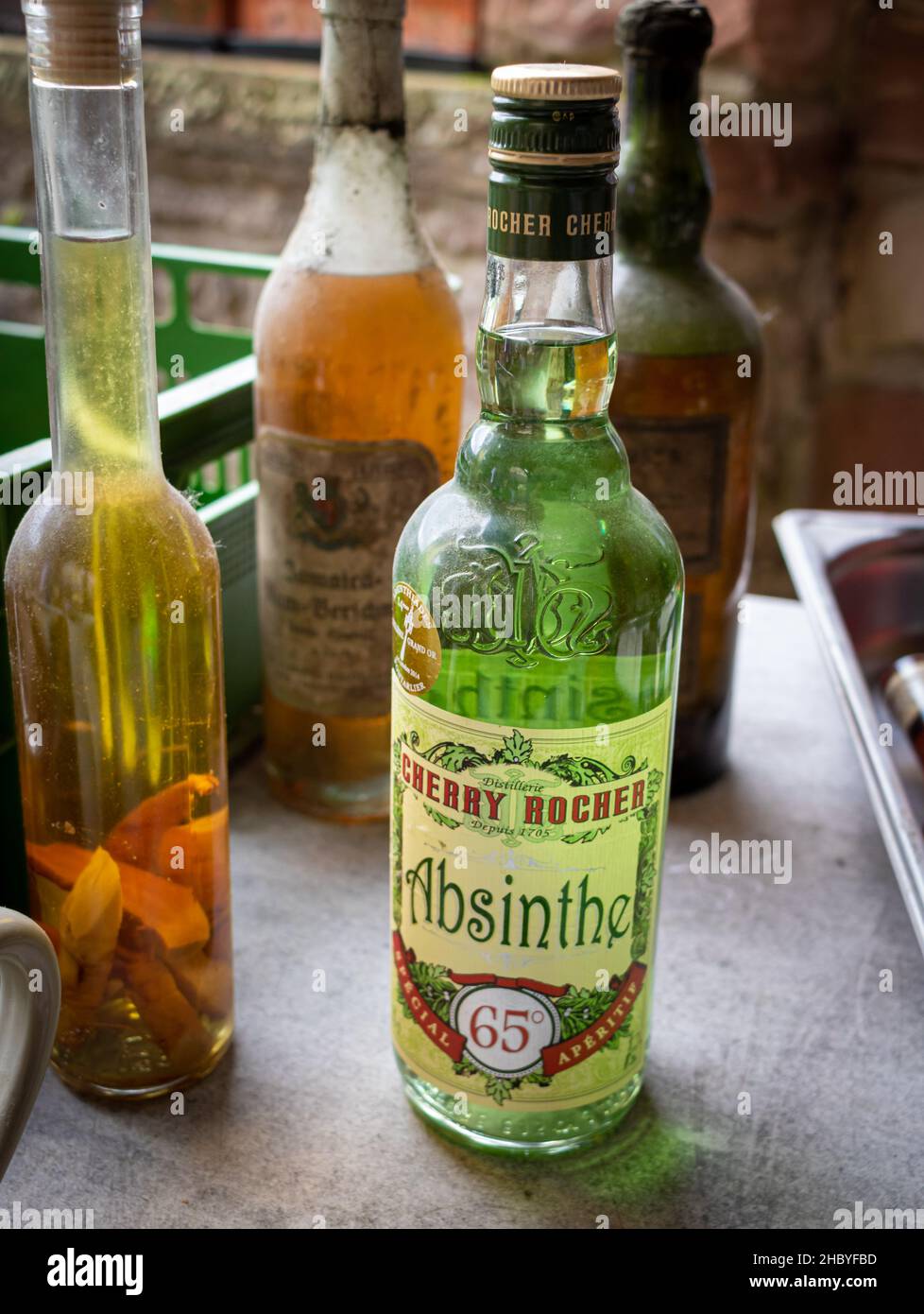 Neckargemuend, Germany - September 11, 2021: A bottle of absinthe and other old liquor bottles at a flea market sale Stock Photo