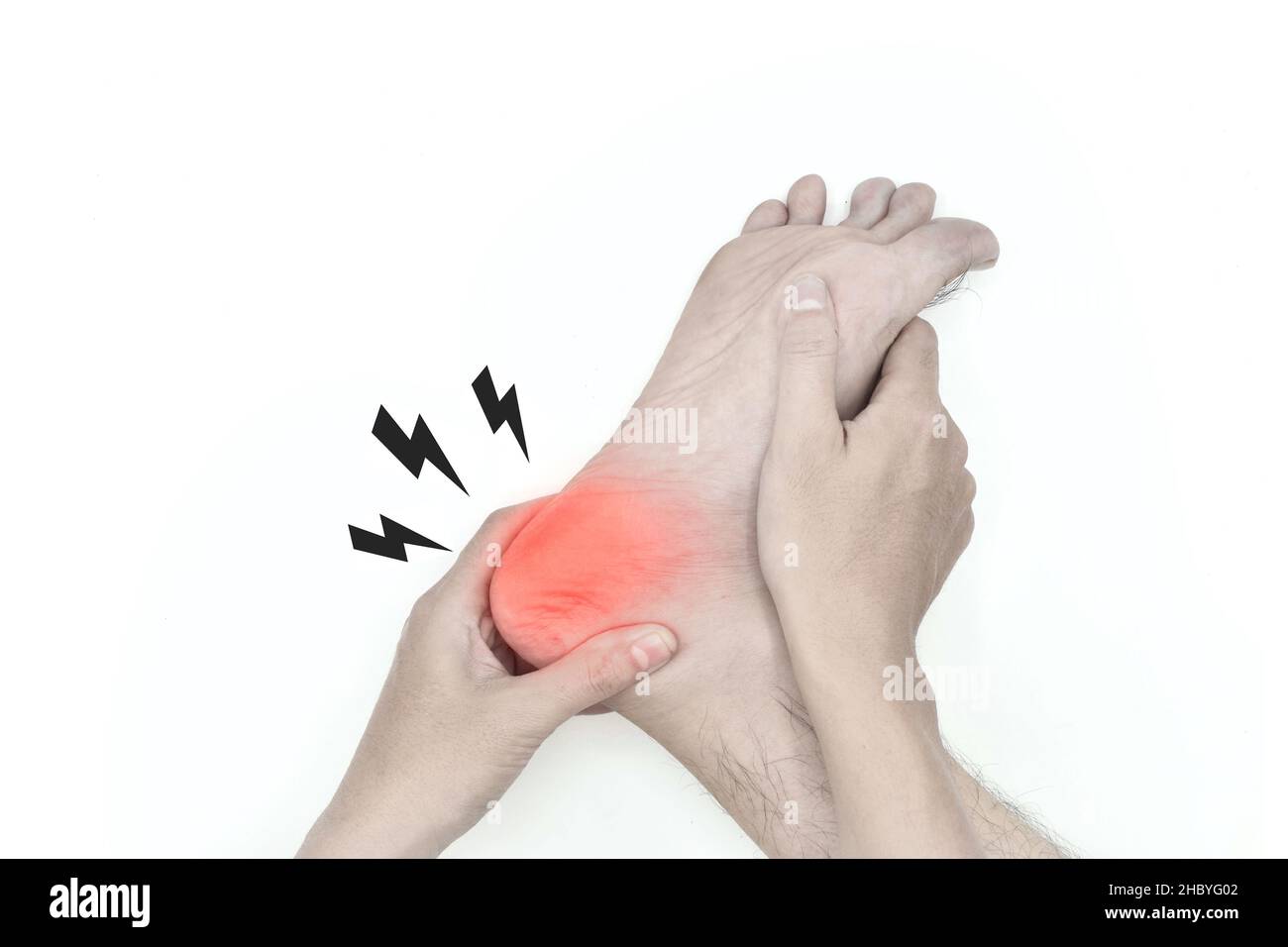 Inflammation in heel of Asian young man. Concept of foot pain, plantar fasciitis, achilles tendonitis or heel spurs. Stock Photo