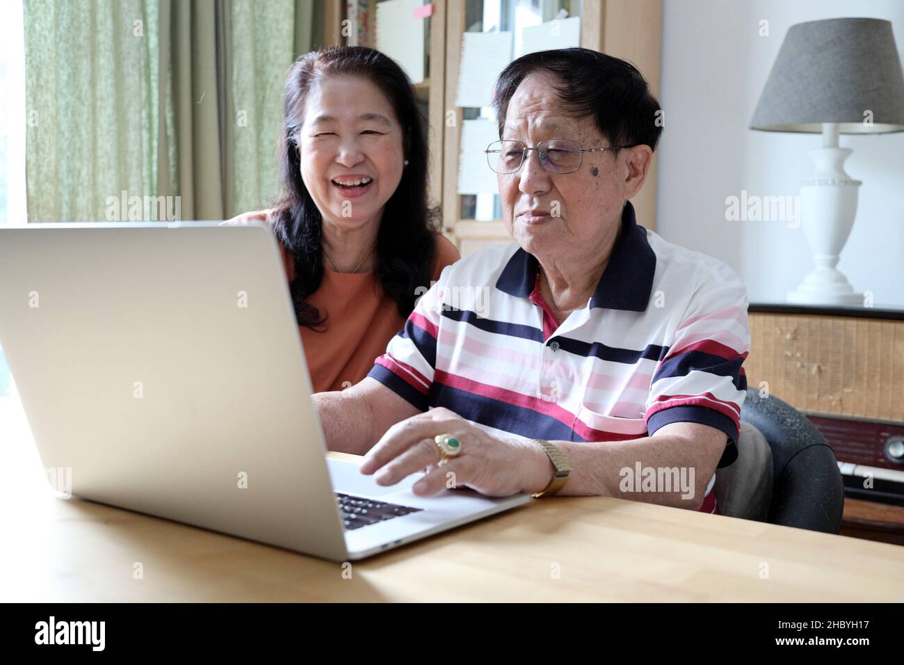 The couple Asian using laptop in the house. Stock Photo