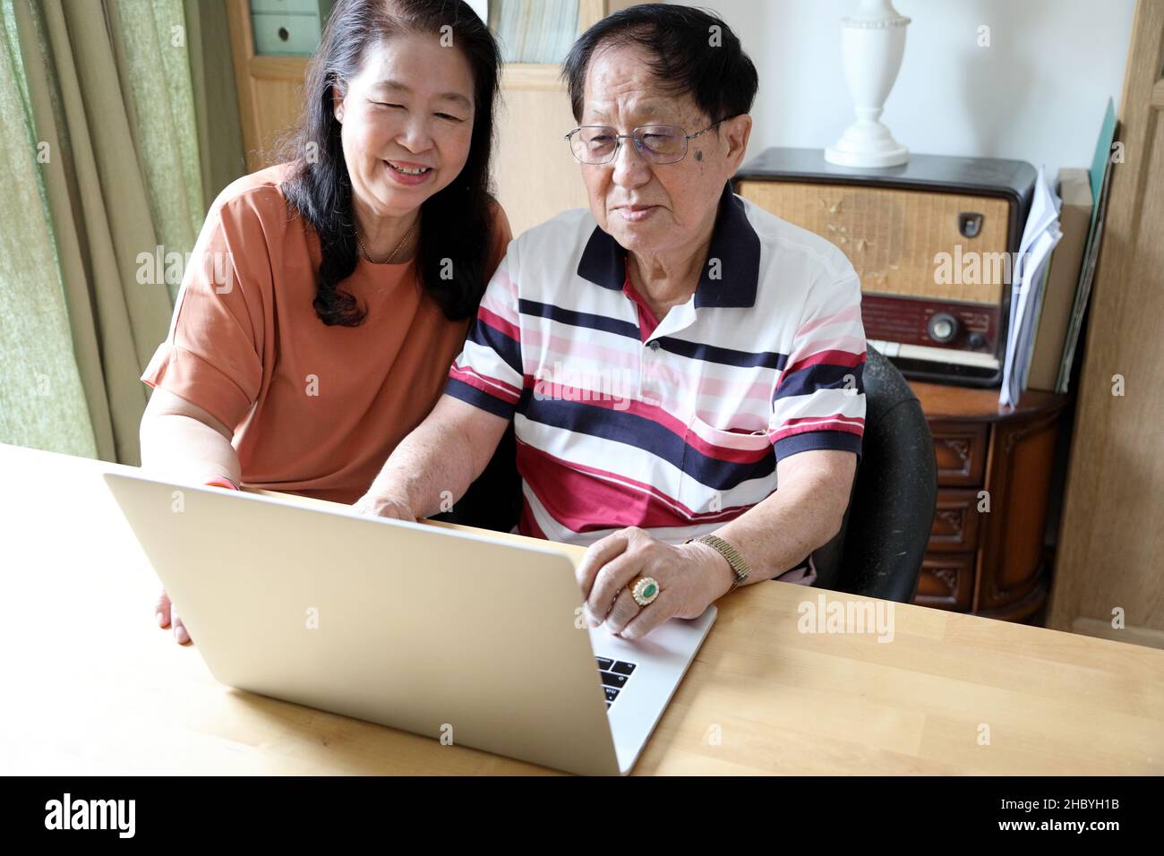 The couple Asian using laptop in the house. Stock Photo