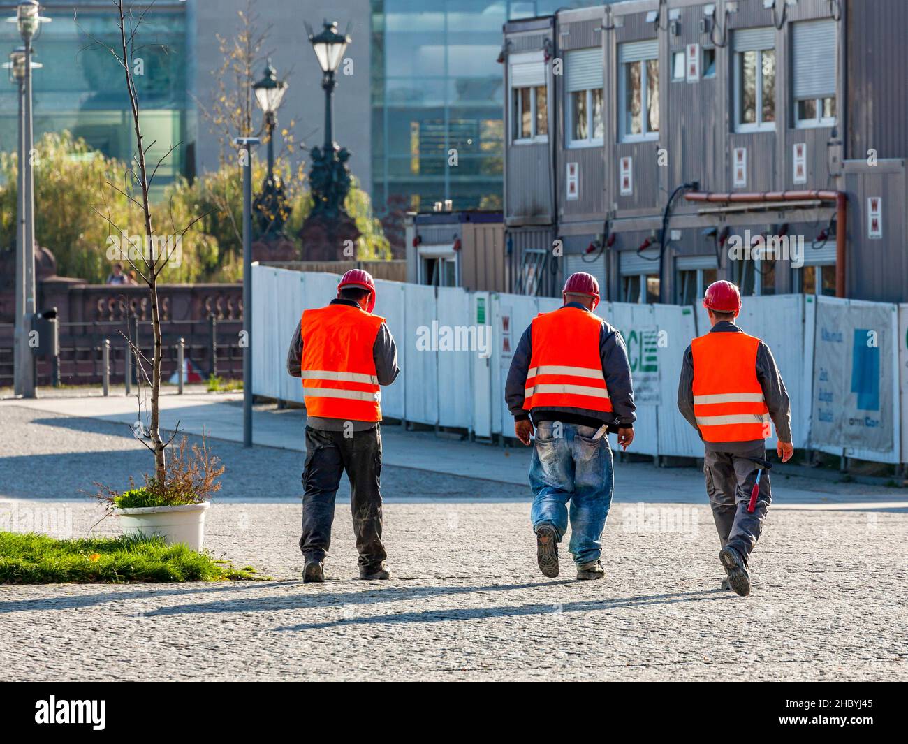 Three construction workers with protective waistcoat and helmet, Berlin, Germany Stock Photo