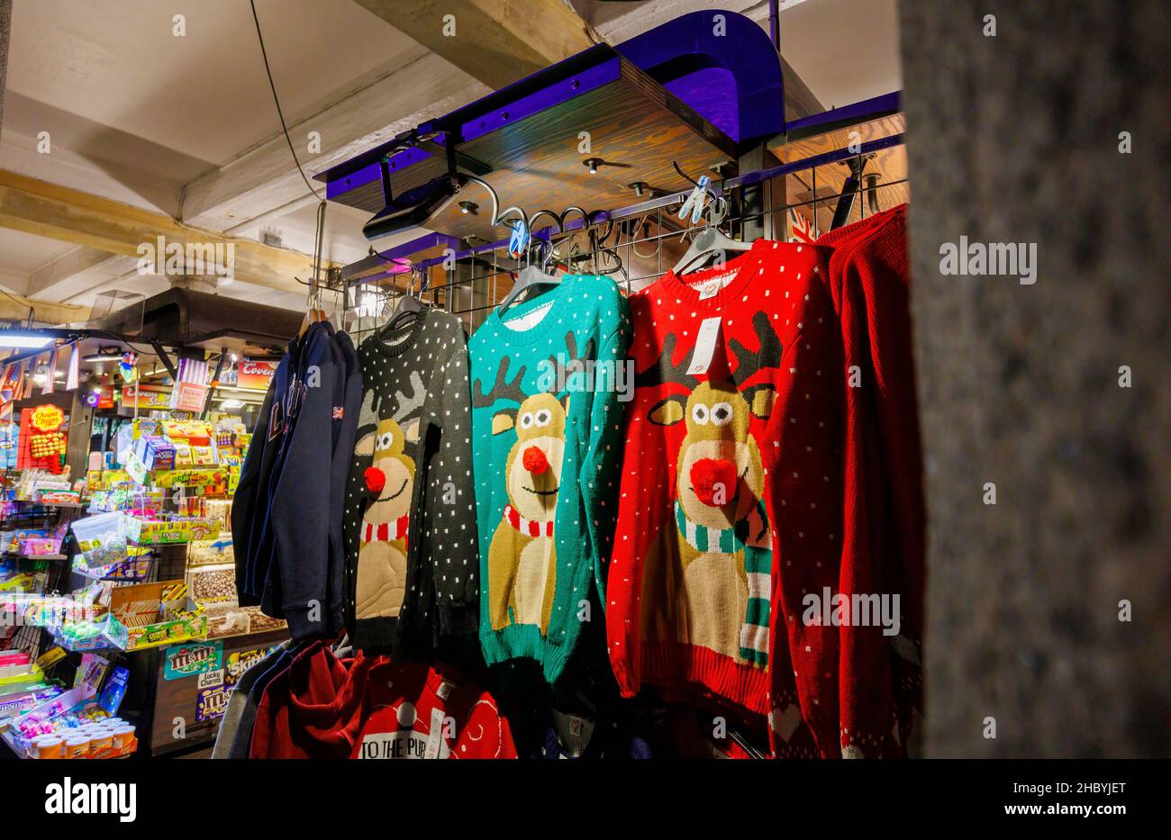 Typical colourful seasonal Rudolph the reindeer sweaters on display for sale in a stall in Covent Garden, London WC2 Stock Photo