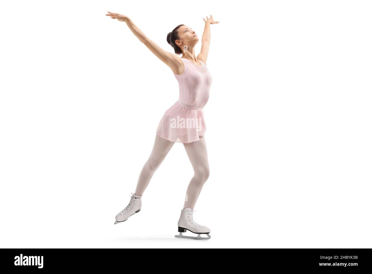 Young female in a pink dress performing ice skating isolated on white background Stock Photo