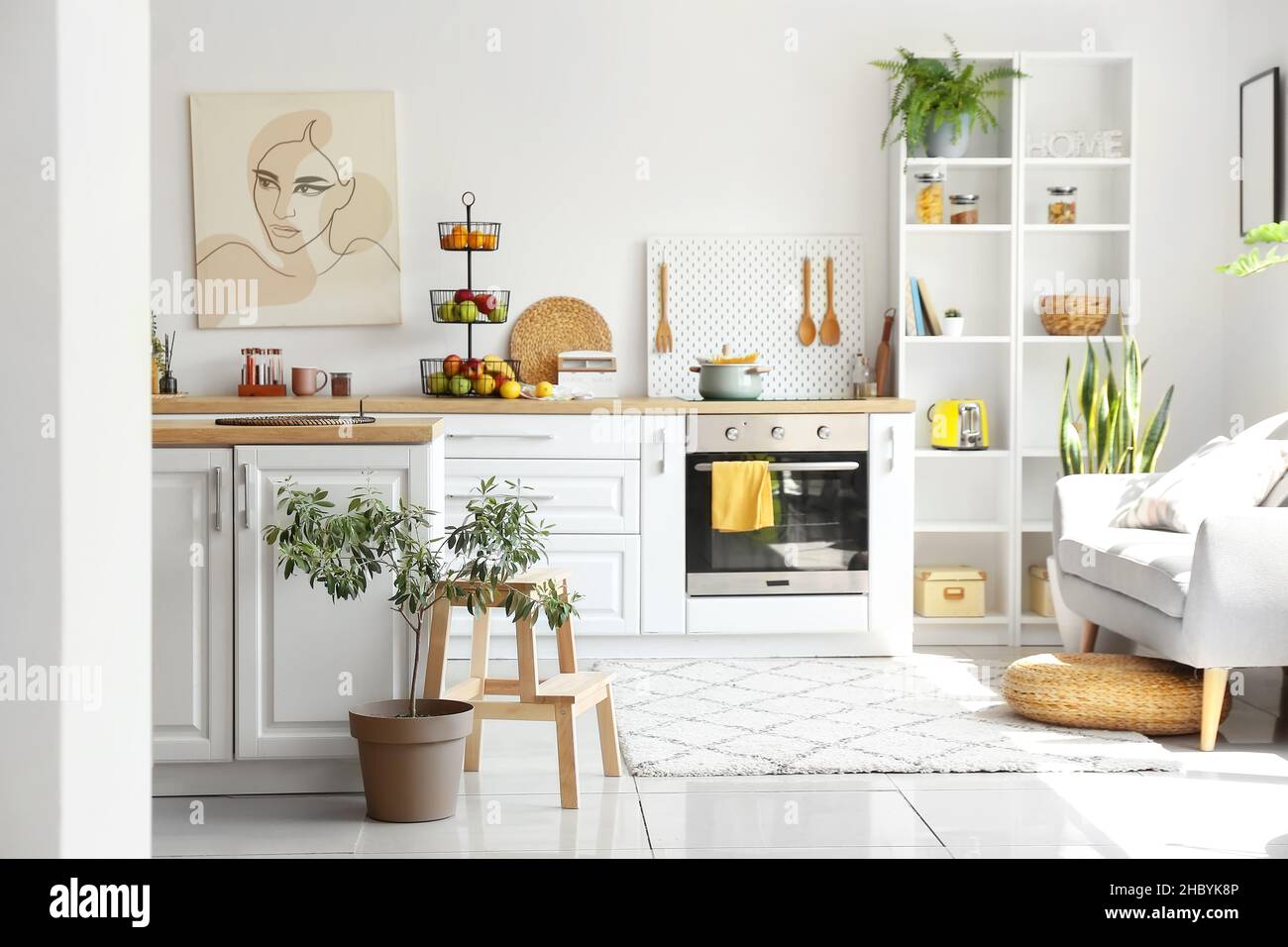 Interior of light modern kitchen with white counters and healthy food ...