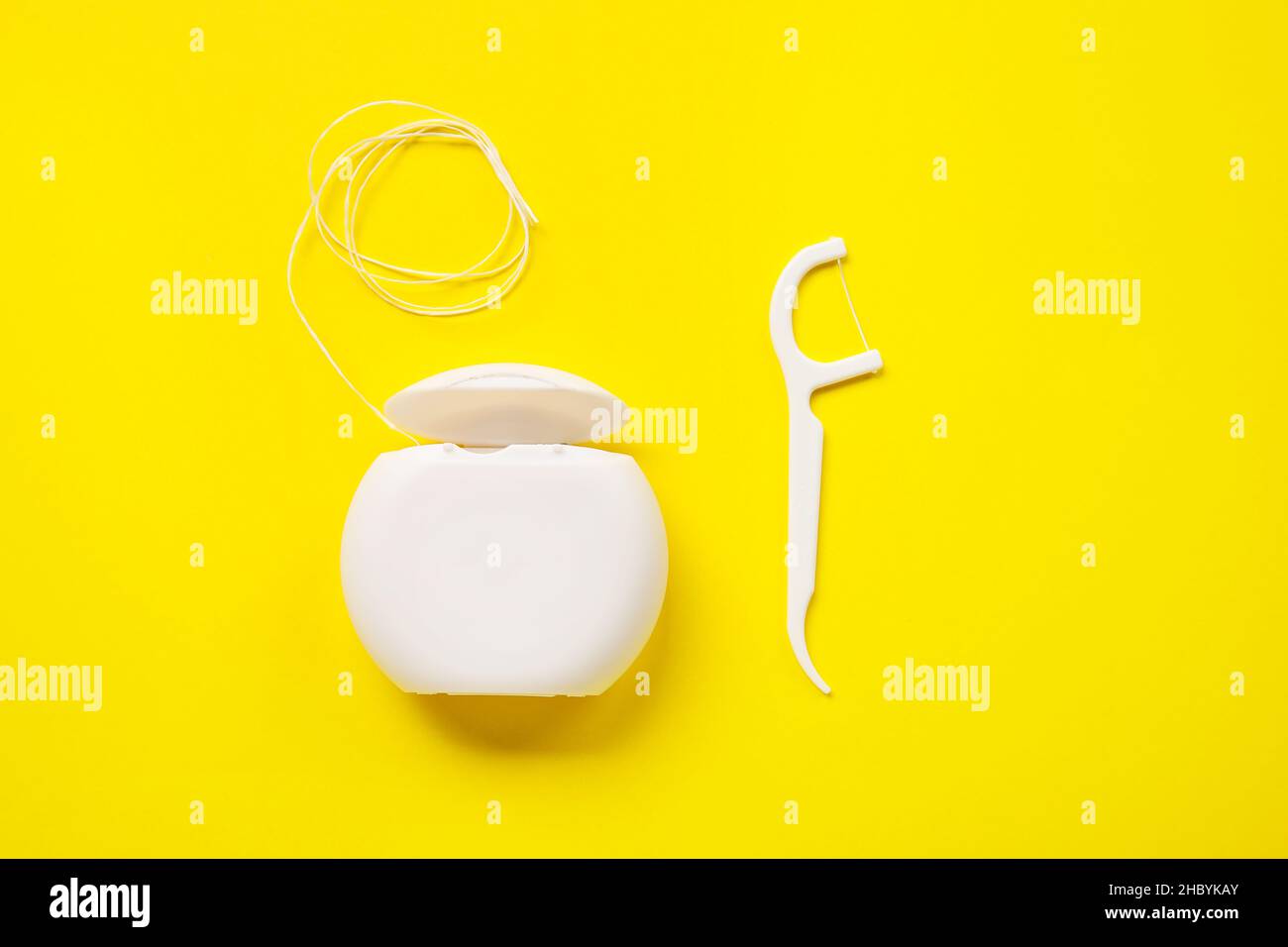 Dental floss and toothpick on yellow background Stock Photo - Alamy