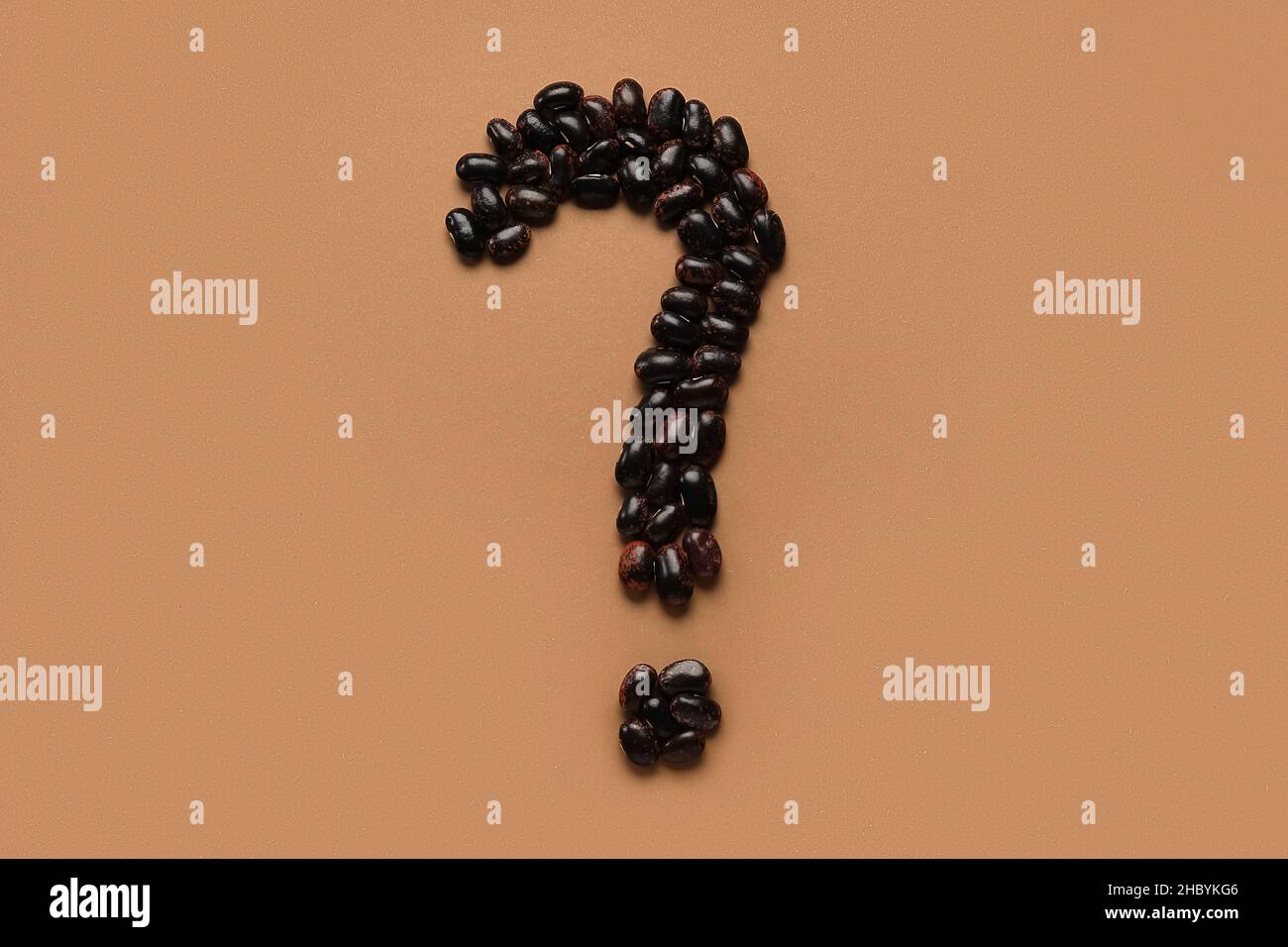 Question mark made of black beans on brown background Stock Photo - Alamy