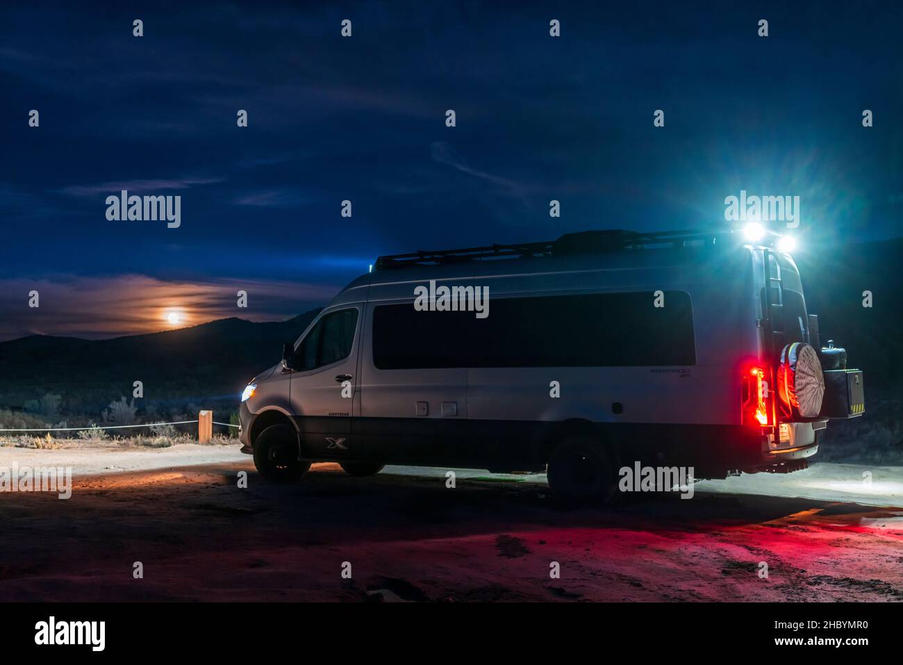 Full moon rising; Airstream Interstate 24X 4WD campervan; Rabbit Valley Camping Area; near Mack; Colorado; USA Stock Photo