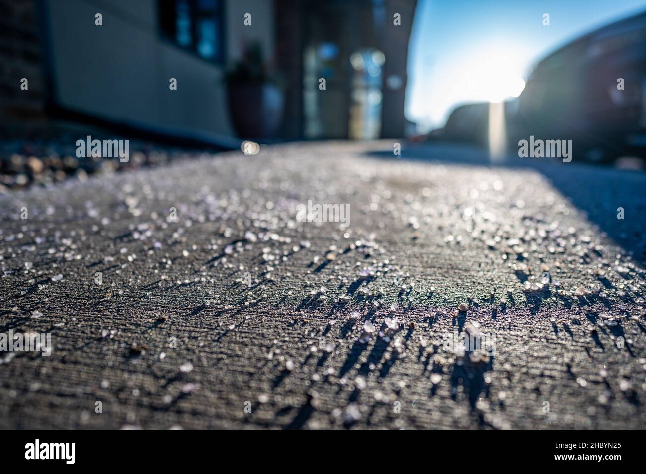 low angle view of salt spread on sidewalk to melt ice and snow Stock