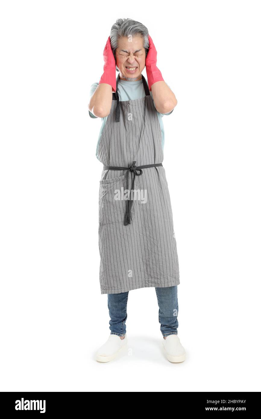 The senior Asian housekeeper standing on the white background. Stock Photo