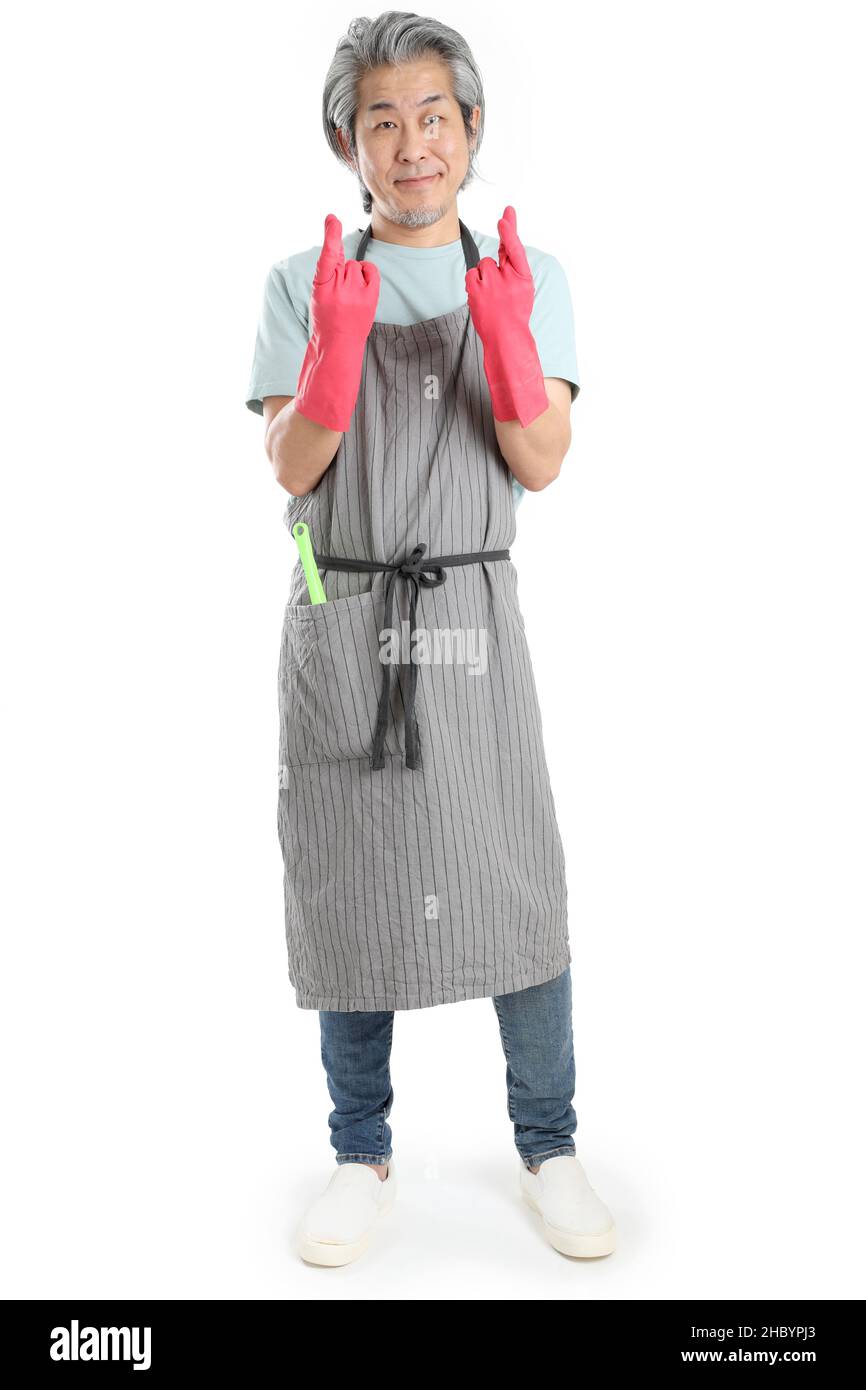 The senior Asian housekeeper standing on the white background. Stock Photo