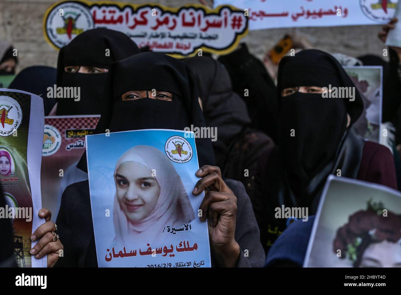Palestinian women attend a protest with female Palestinian prisoners held in Israeli jails, outside the Red Cross office in Gaza city, on Dec 22, 2021 Stock Photo