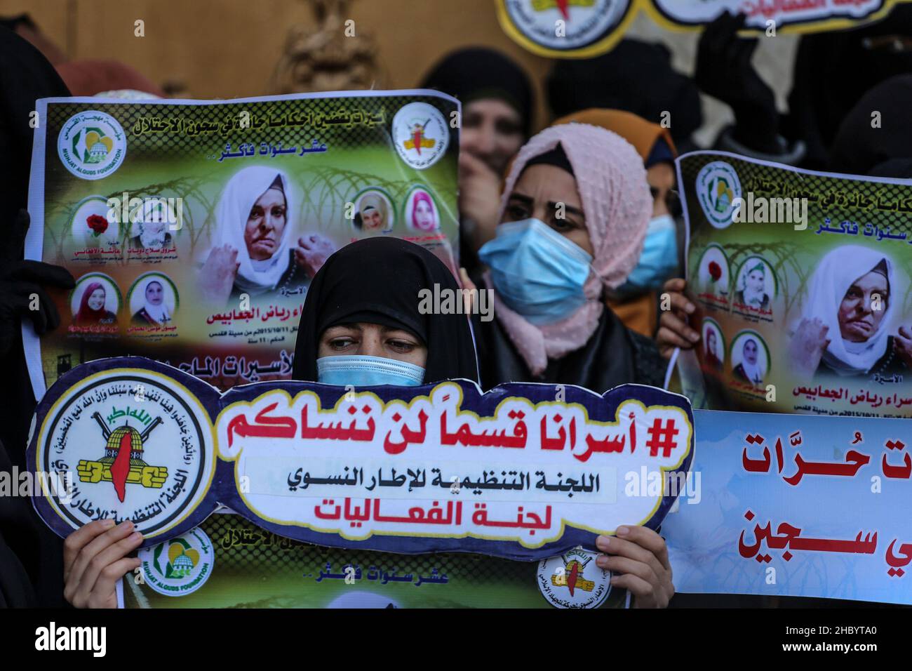 Palestinian women attend a protest with female Palestinian prisoners held in Israeli jails, outside the Red Cross office in Gaza city, on Dec 22, 2021 Stock Photo