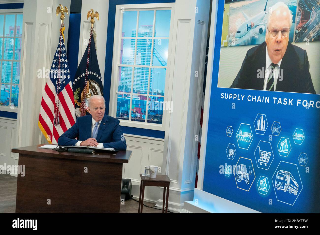 United States President Joe Biden listens as Fred Smith, CEO of FedEx