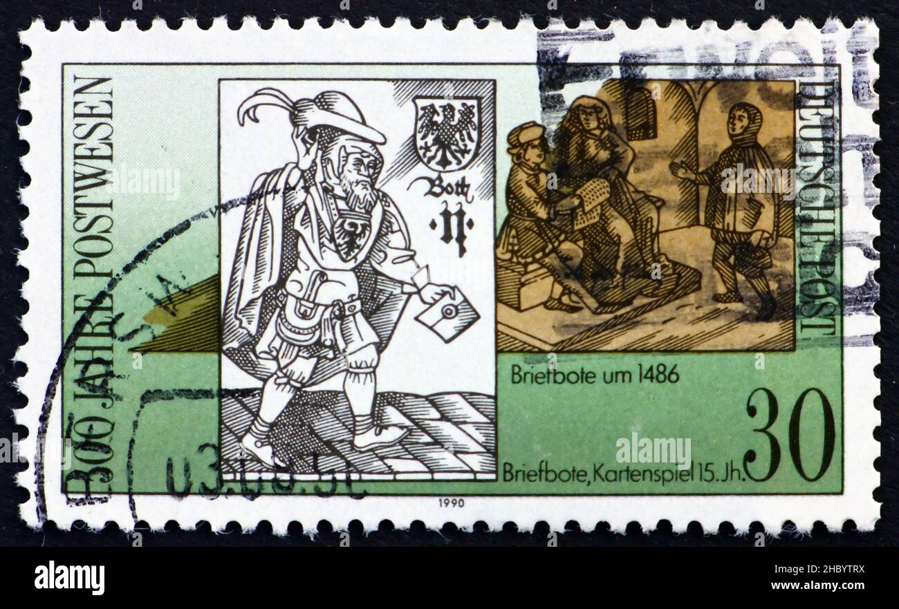 GDR - CIRCA 1988: a stamp printed in GDR shows 15th Century Postman, 500th Anniversary of Postal System, circa 1988 Stock Photo