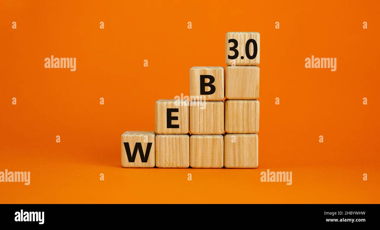WEB 3.0 symbol. Wooden cubes with concept words WEB 3.0. Beautiful orange table, orange background, copy space. Business, technology web3 and WEB 3.0 Stock Photo