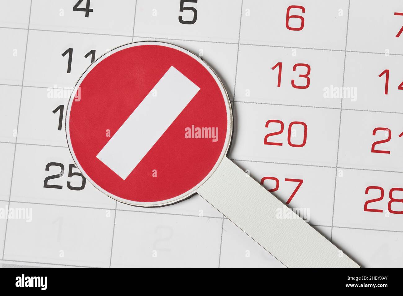 Closeup view of monthly calendar and No entry traffic sign. Symbol of