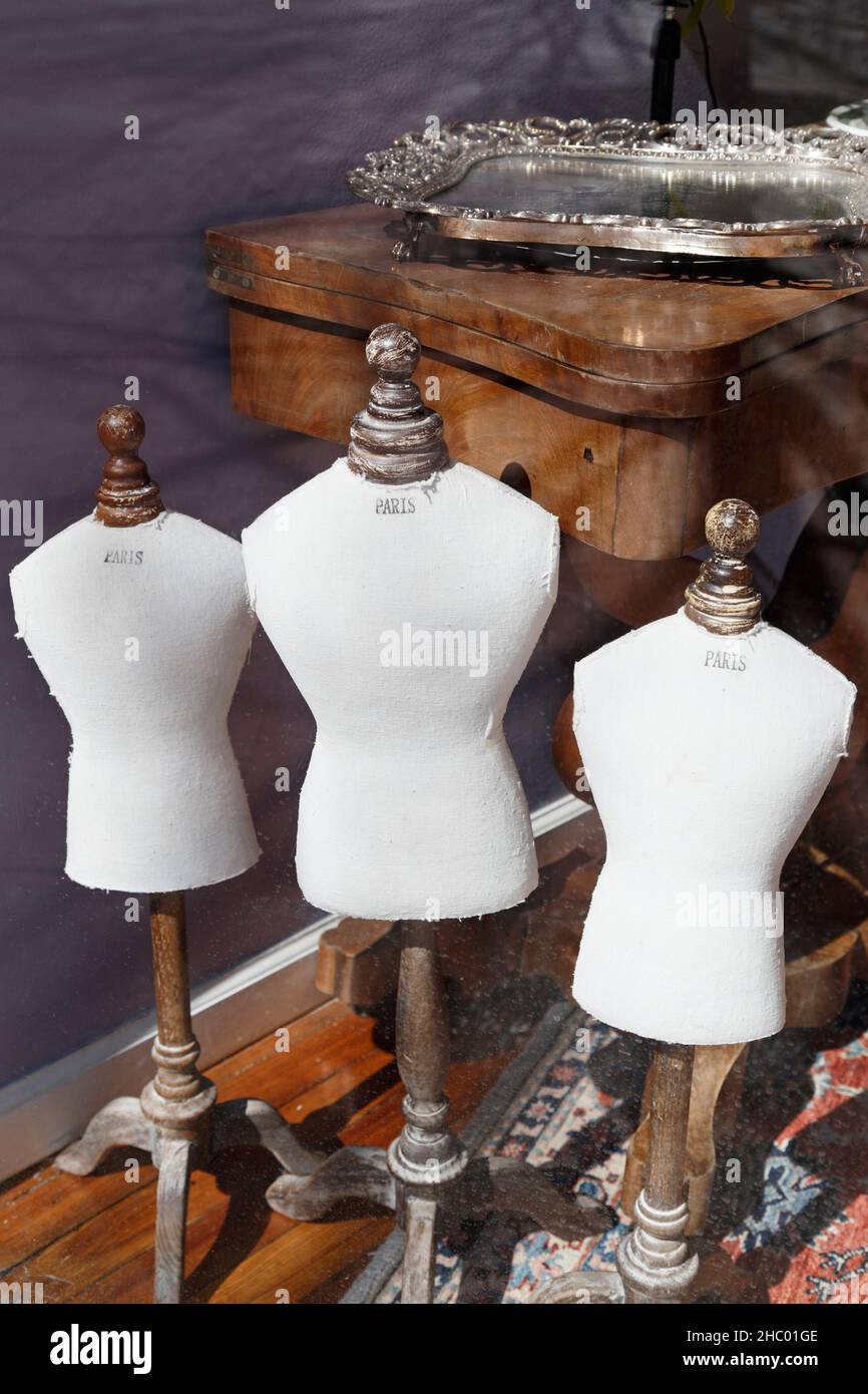 Miniature mannequins in an Antique store window Stock Photo