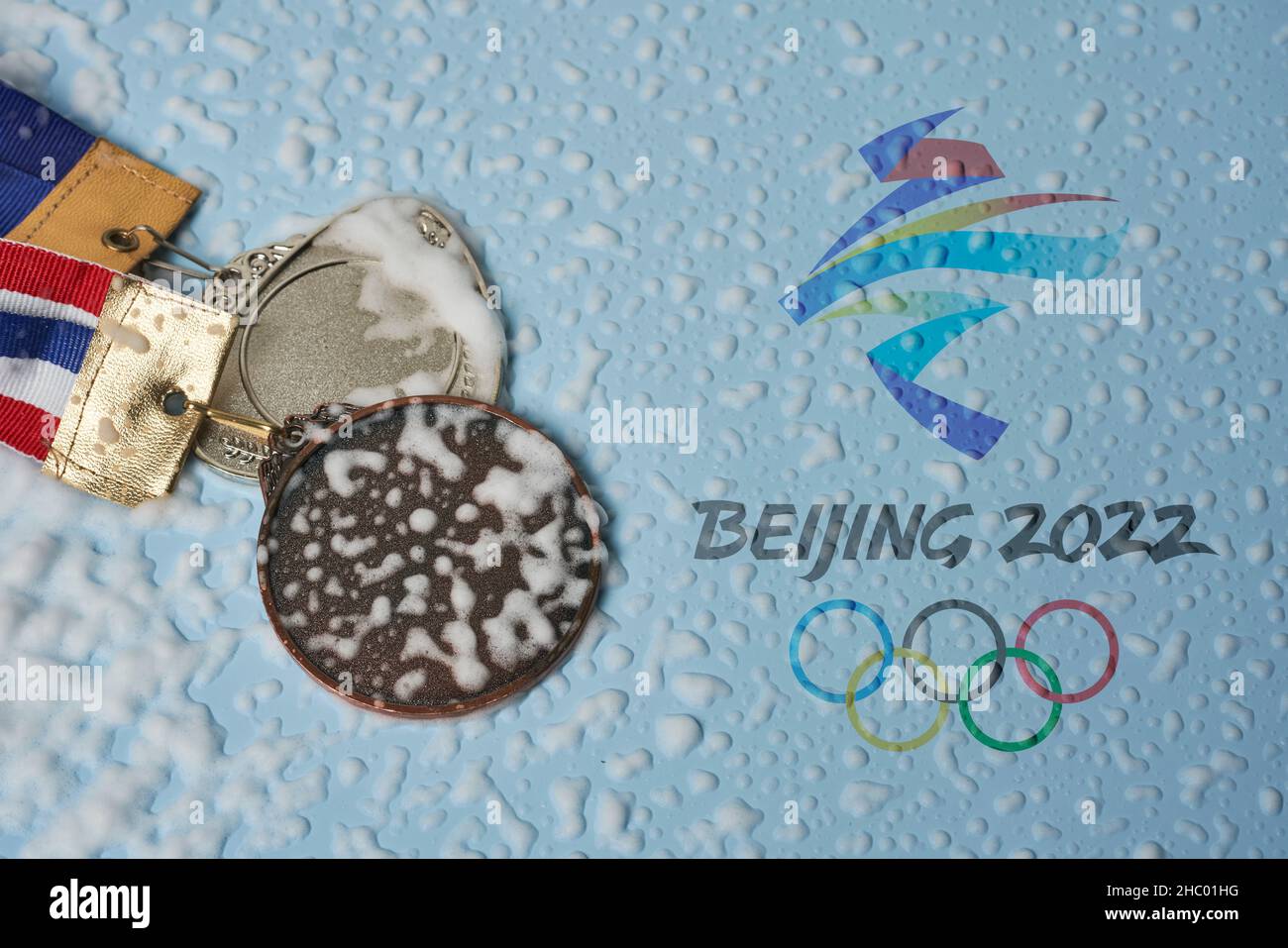14 December 2021 - Los Angeles, USA: Olympic medals and Beijing 2022 Olympic Games symbol. Winning medals at 2022 Winter Olympics in Beijing, China Stock Photo