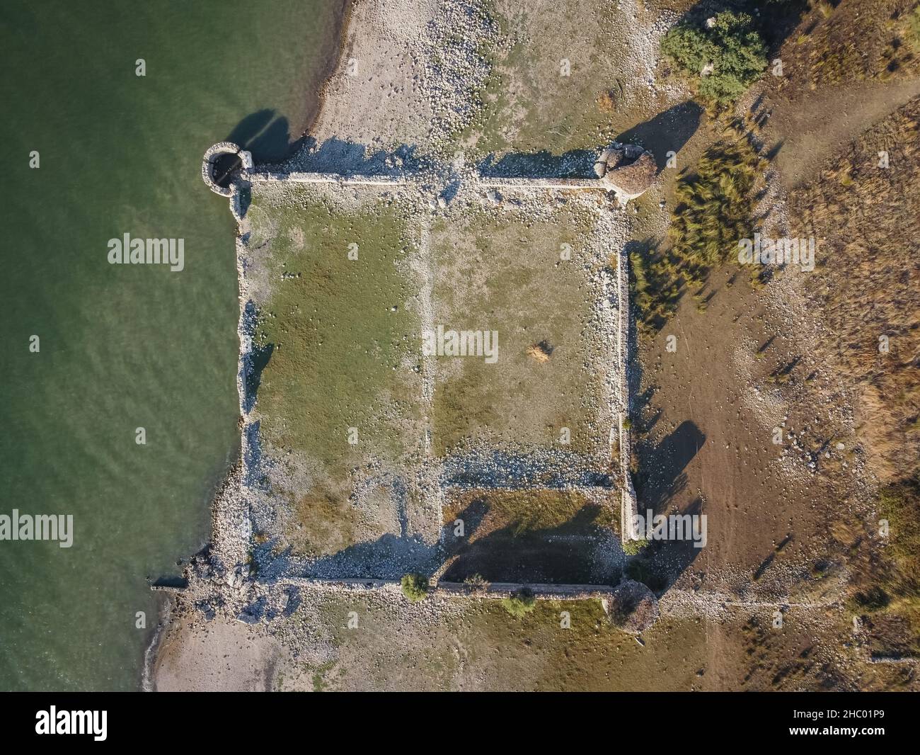 Aerial drone. Fortino di Mazzallakkar, ruined Arab fort in Sambuca di Sicilia, Sicily. Located on Lago Arancio, it's occasionally submerged by water. Stock Photo
