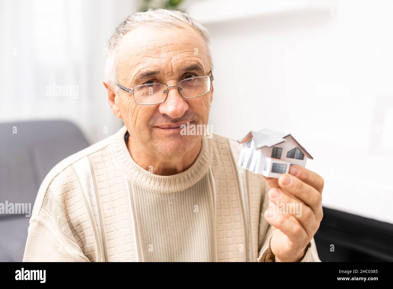 Portrait Of Handsome Astonished Person Arm Hold Key Small House Stock