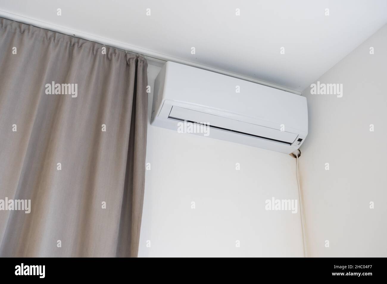 Air conditioner on a white wall background Stock Photo - Alamy