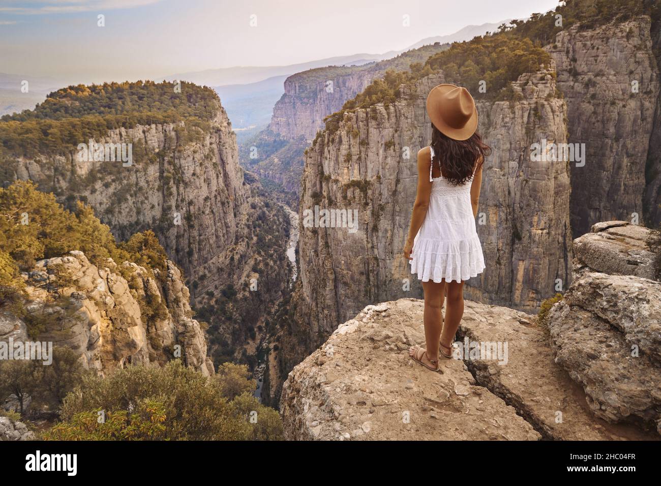 Tourist woman on the edge of a cliff of Tazi Canyon in Manavgat, Antalya, Turkey. Greyhound Canyon, Wisdom Valley. Stock Photo