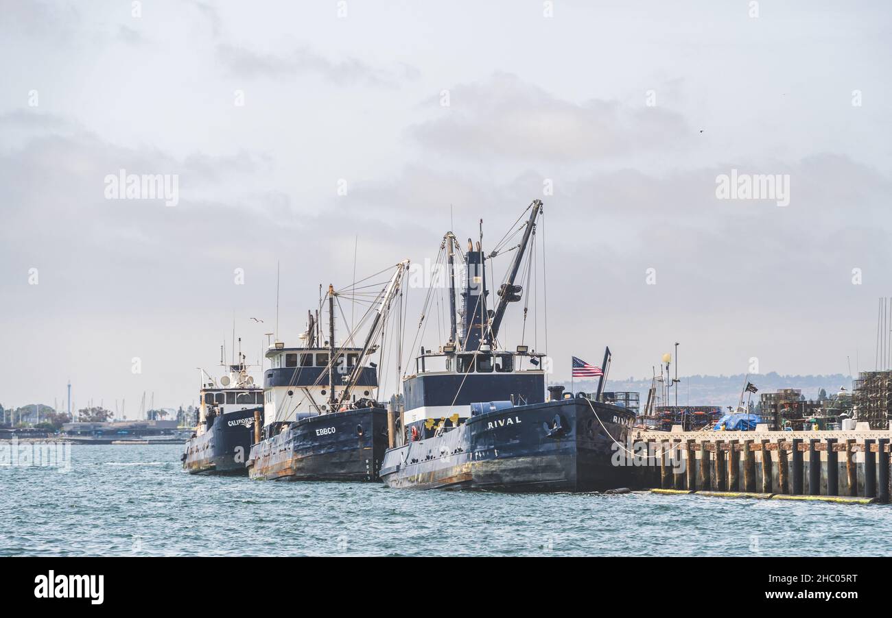 Commercial Fishing Trawlers docked in San Diego harbor on beautiful summer day Stock Photo