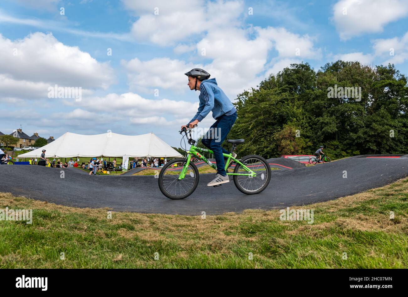 Boy riding a bicycle at opening event at Ormiston BMX pump track, East