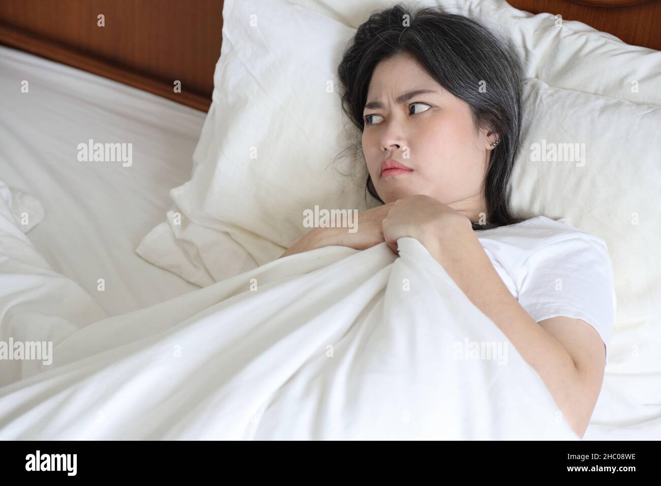 The Asian woman relaxing on the bed Stock Photo - Alamy