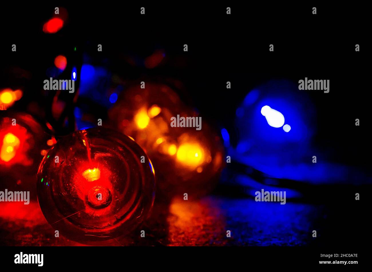 Colored globe lights lay on a table, Dec. 27, 2017, in Coden, Alabama. Globe-style string lights can be used inside or outdoors for a festive touch. Stock Photo