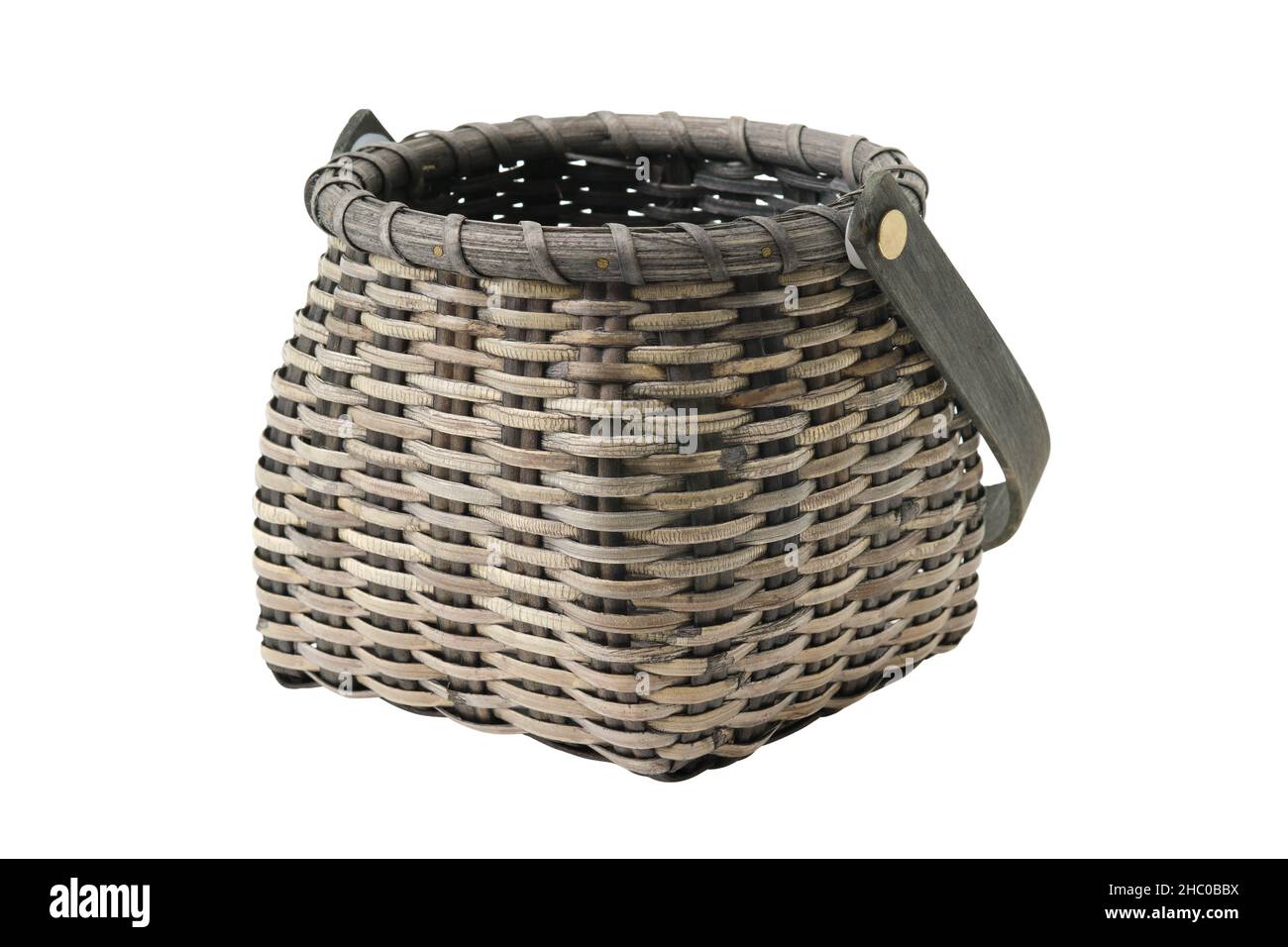 Dark wicker vintage rustic basket, isolated on white background Stock
