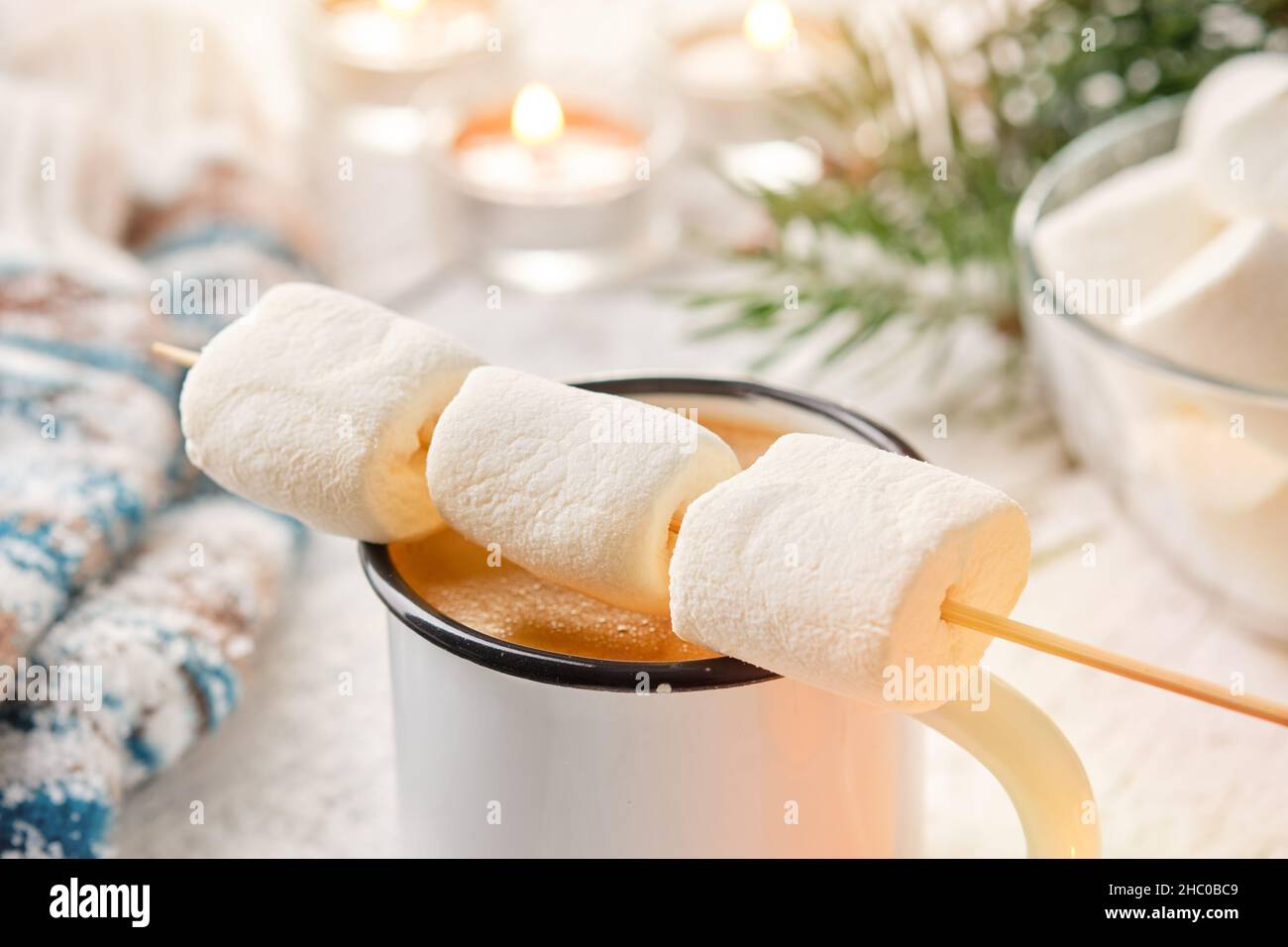 Hot coffee or chocolate mug and skewer with marshmallow  for roasting. The concept of cosy holidays and winter. Stock Photo