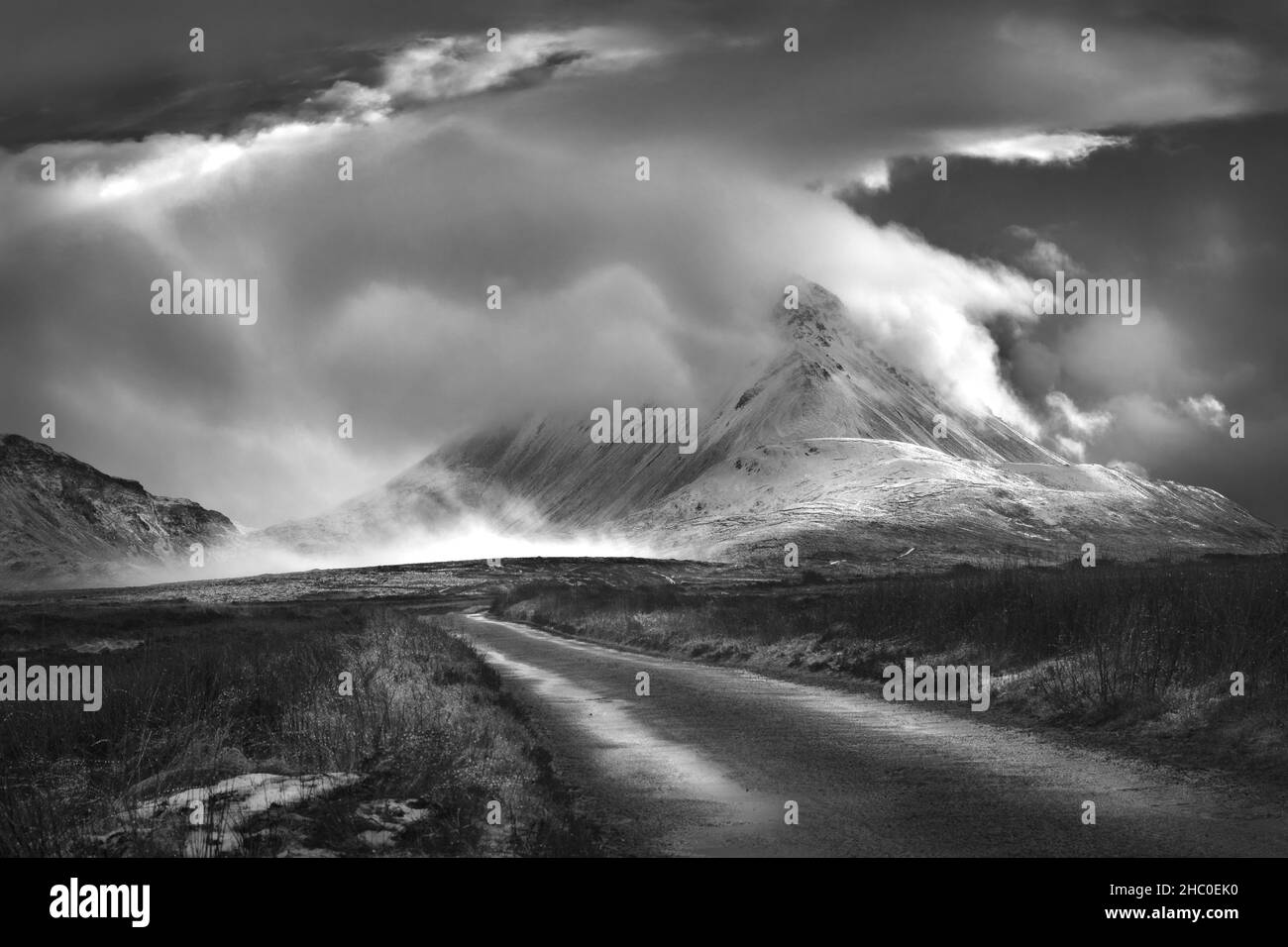 The snow-capped Mount Errigal shrouded in storm clouds. The Errigal peak in west Donegal is a popular spot for tourists and mountain climbers. Stock Photo