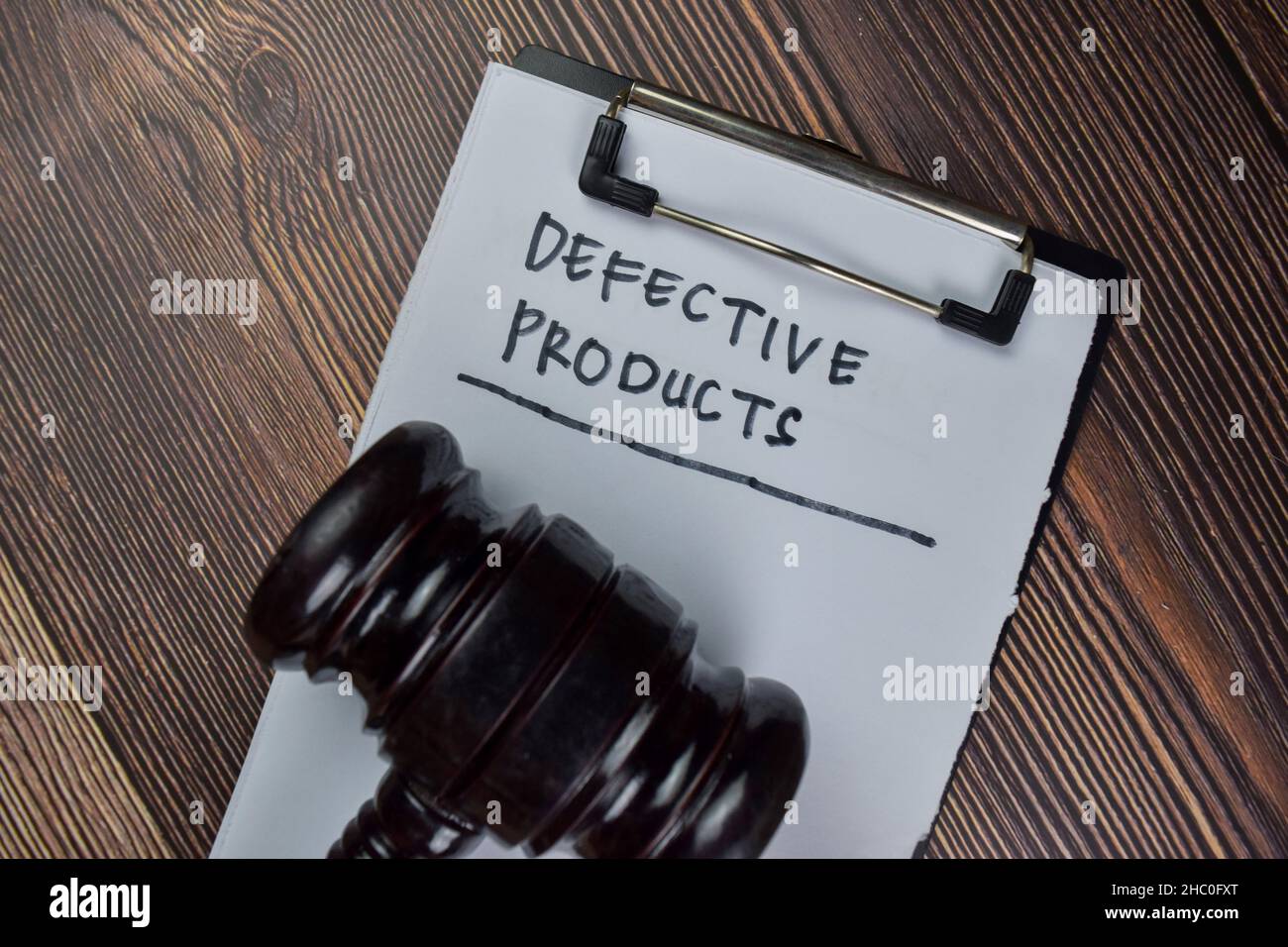 Defective Products write on a paperwork isolated on Wooden Table. Stock Photo