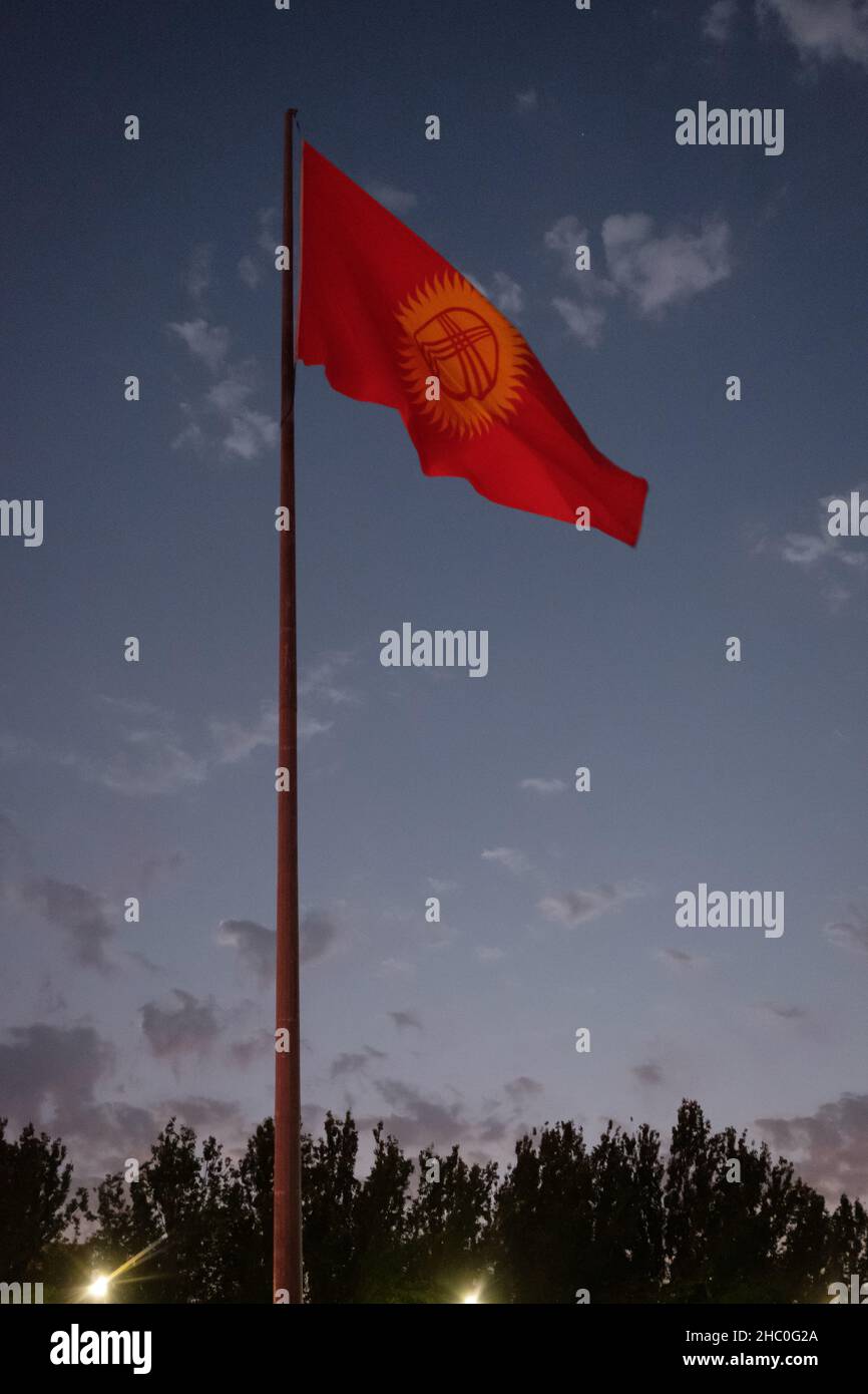 Flag of Kyrgyzstan at night Stock Photo