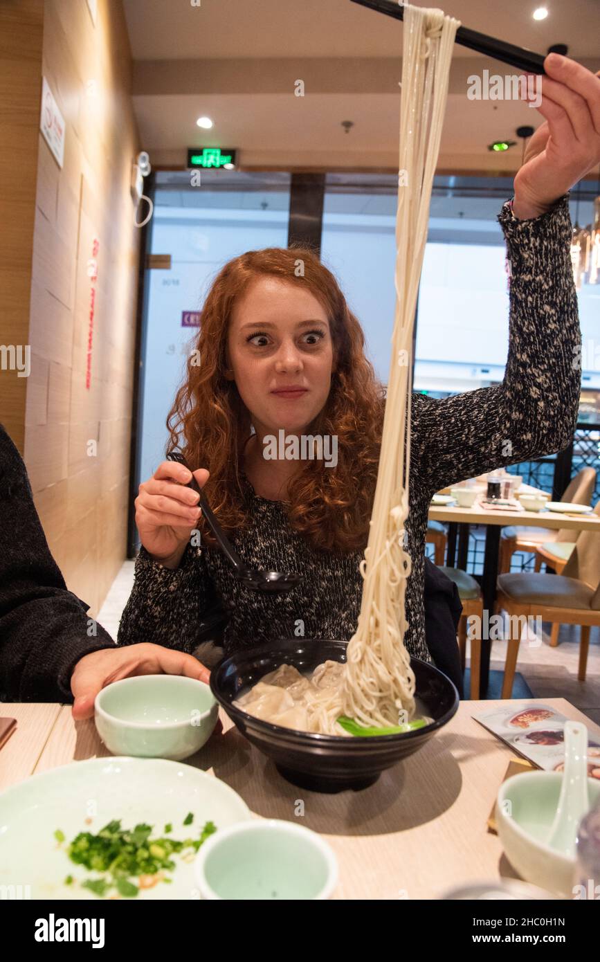 February 2019, Shangahi. Italians in a typical restaurant eat local food Stock Photo