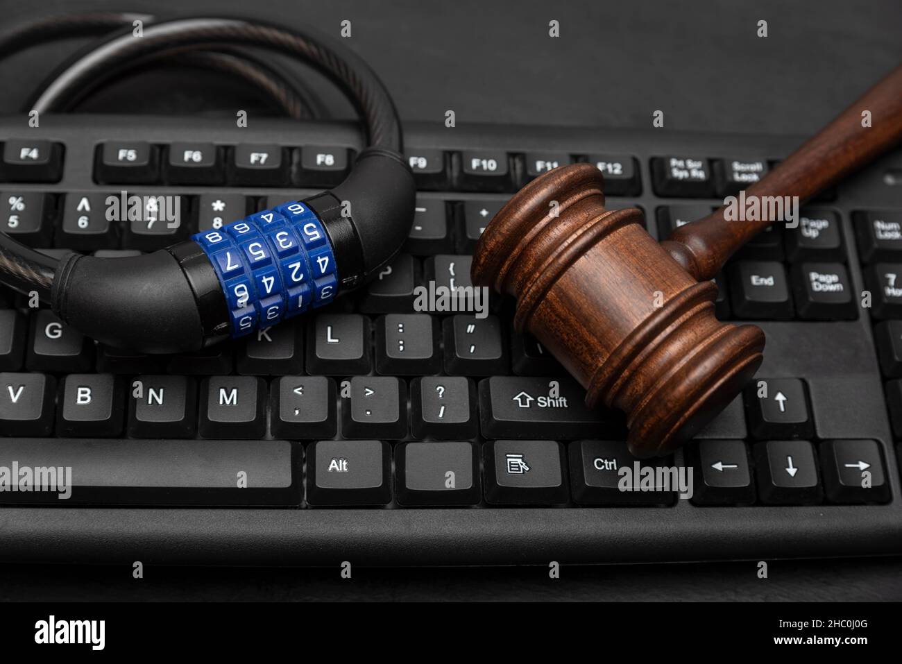 Gavel with combination lock on computer keyboard. Data Protection Concept Stock Photo