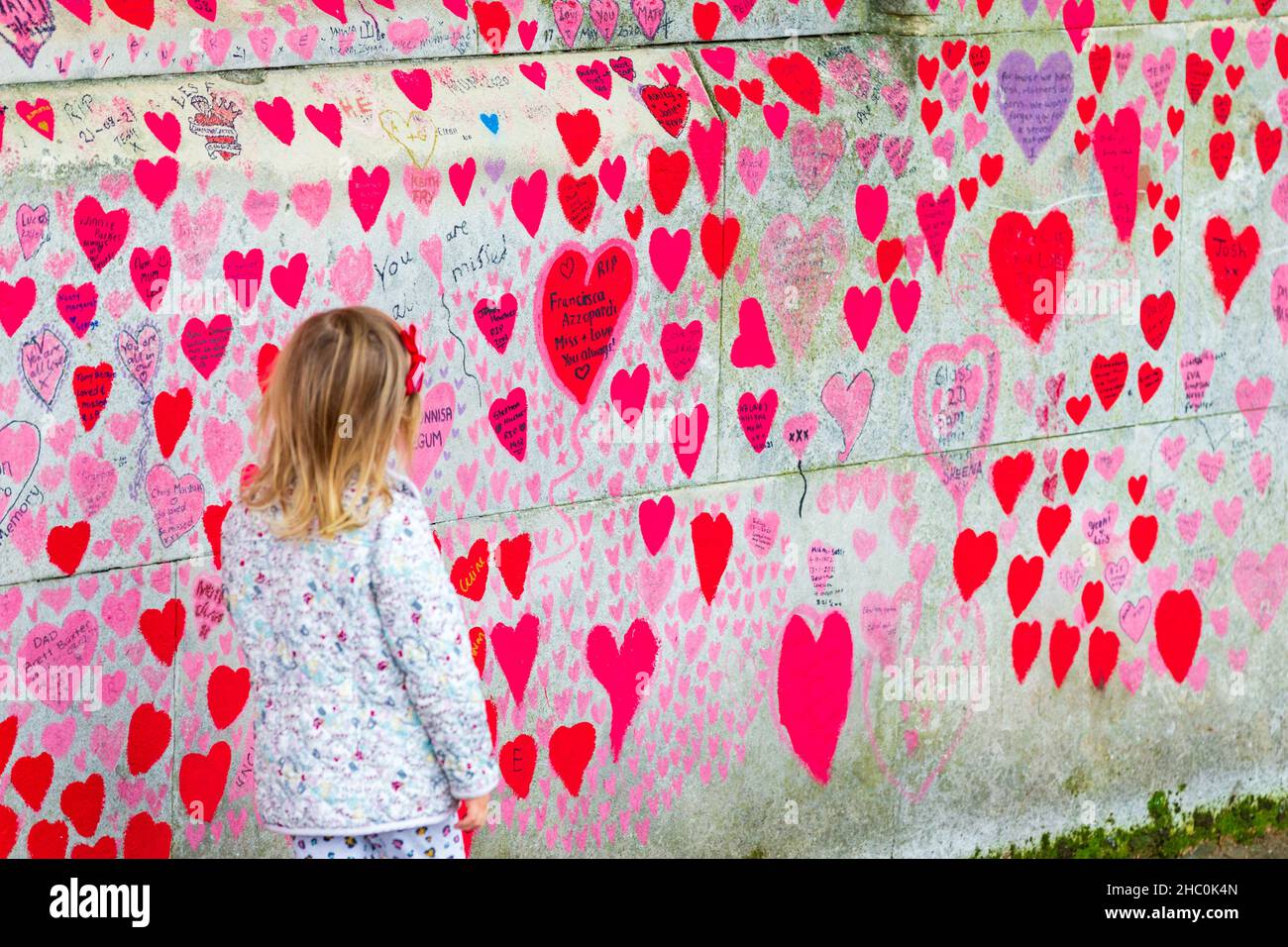 Little girl at the national covid memorial wall, london, uk Stock Photo